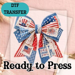 May include: A patriotic bow with red, white, and blue fabric patches, featuring stars, stripes, and American flag imagery. The bow includes the text "DTF TRANSFER" and "Ready to Press".