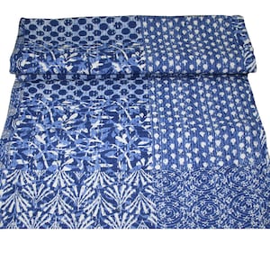 May include: A blue and white kantha quilt with a patchwork design. The quilt is made of cotton and has a variety of patterns, including dots, swirls, and leaves.