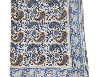 May include: A white cotton quilt with a blue and brown paisley pattern. The quilt has a border of blue and white floral designs.