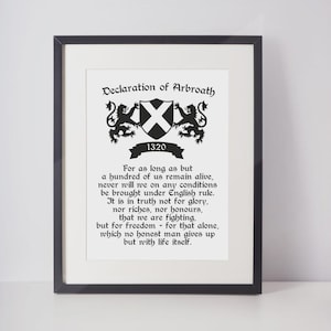 May include: Framed print of the Declaration of Arbroath, a historical document. The black frame surrounds a white background with black text and a crest. The text includes the year 1320 and a quote about freedom.