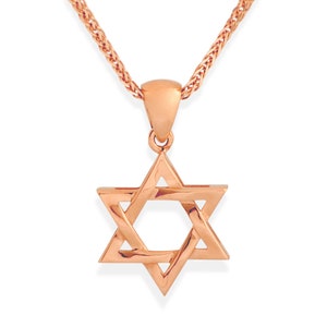 May include: A rose gold Star of David pendant necklace. The pendant is a six-pointed star, suspended from a matching chain. The necklace is displayed against a white background.