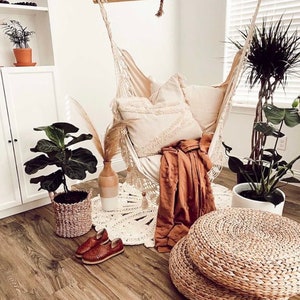 lifestyle photo of a hammock chair with a cozy blanket