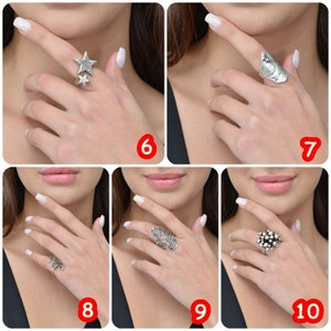 May include: Five silver rings with different designs. The rings are shown on a model's fingers.