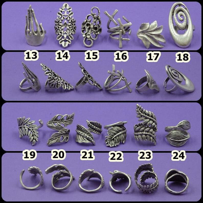 May include: Set of 24 silver-toned rings with various designs, including leaf, spiral, and geometric patterns. The rings are numbered 13 through 24.