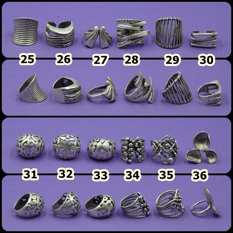 May include: A collection of 36 silver rings with various designs. The rings are arranged in rows of six, with numbers 25 through 36 below each row.