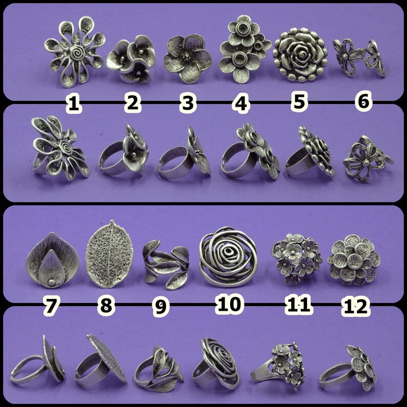 May include: Twelve silver-toned rings with various floral and leaf designs. The rings are arranged in four rows of three. The rings are all different sizes and shapes.