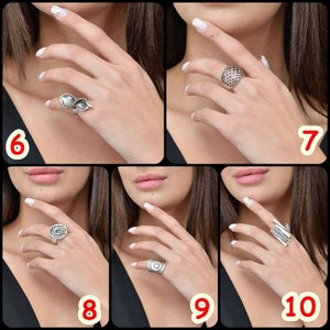 May include: A set of silver rings with different designs. The rings are shown on a model's hand.