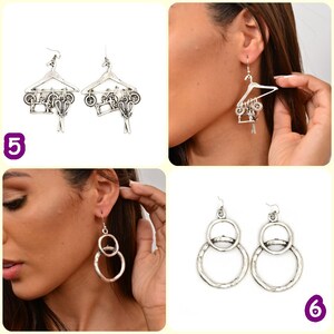 May include: Two pairs of silver earrings. The first pair features a hanger with a motorcycle and scissors hanging from it. The second pair features two interlocking circles.