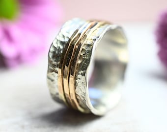 Hammered silver ring with three movable gold rings