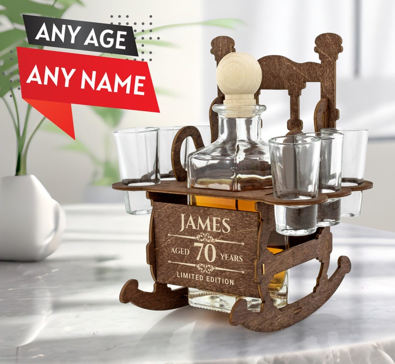 May include: Wooden liquor dispenser shaped like a rocking chair with a bottle and four shot glasses. The dispenser is personalized with the name "JAMES" and the text "AGED 70 YEARS LIMITED EDITION".