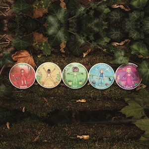 May include: Six colorful round wooden discs with illustrations of people performing math equations. The discs are labeled "Divide", "Multiply", "Add", "Subtract", "Equals", and "Add".