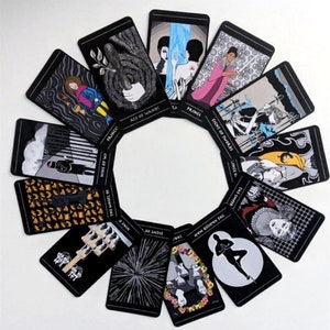 May include: A set of tarot cards with black backgrounds and colorful illustrations. The cards are arranged in a circle, with the names of the cards visible. The cards include the Ace of Wands, Prince, Eight of Swords, Nine of Wands, The Hanged Man, The Wheel of Fortune, Eight of Pentacles, and Nine of Cups.