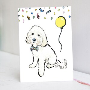 Könnte beinhalten: Ein weißer Hund mit einer Schleife und einem gelben Ballon. Der Hund sitzt auf einem weißen Hintergrund mit bunten Konfetti.