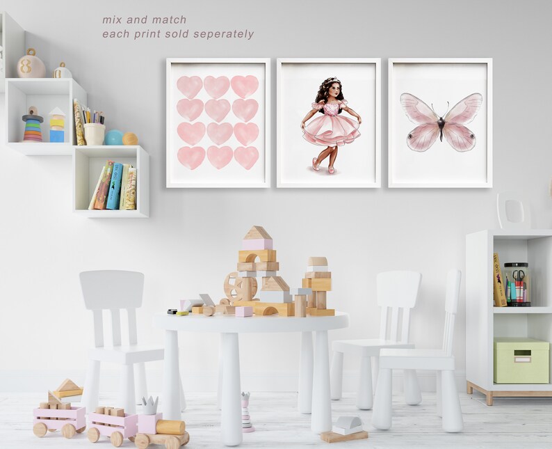 May include: Three framed art prints with white frames. The prints feature a watercolor design of pink hearts, a ballerina in a pink dress, and a pink butterfly. The text "mix and match each print sold separately" is at the top.