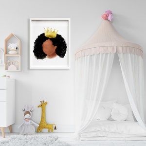 May include: A framed watercolor print featuring a profile of a person with dark skin, black curly hair, and a gold crown. The artwork is displayed in a white frame, suitable for a nursery or children's room decor.