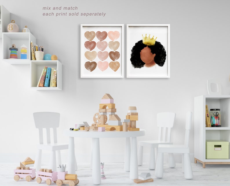 May include: Two framed art prints. One features twelve watercolor hearts in shades of brown and pink. The other depicts a Black woman with a gold crown. The text "mix and match each print sold seperately" is visible.