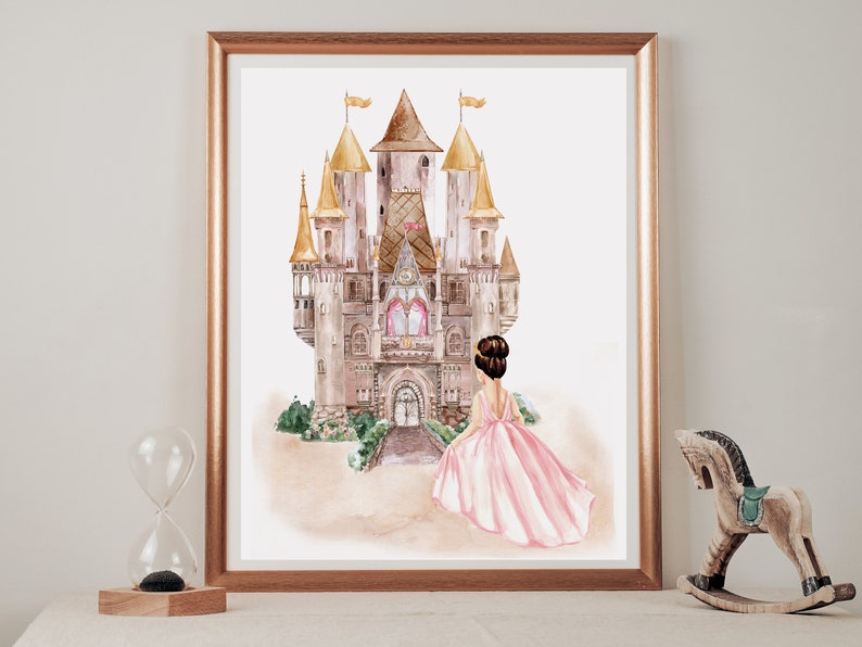 May include: A framed watercolor print featuring a large castle with golden spires and a central clock tower. In the foreground, a figure with dark hair styled in a bun wears a flowing pink gown, facing toward the castle entrance with green bushes.