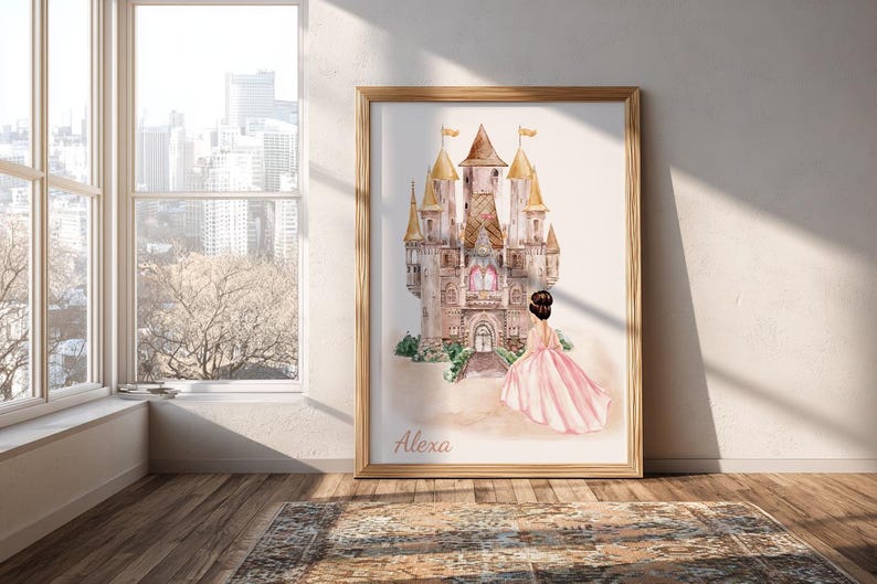 May include: A framed watercolor print featuring a tall, multi-towered castle in shades of tan and brown with gold-toned spires. A figure in a flowing pink gown stands before the castle entrance. The name Alexa is printed in script at the bottom.