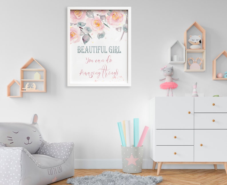 May include: A white framed print with a watercolor illustration of pink flowers and the text "Beautiful Girl You can do Amazing Things".