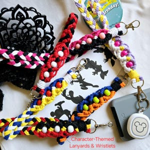 May include: Character-themed lanyards and wristlets in various colors. Braided designs feature red, black, white, yellow, blue, and pink. Each lanyard has a metal clasp. Some have decorative beads. A Mickey Mouse silhouette is in the background.