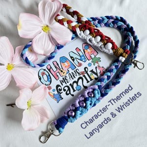 May include: Character-themed lanyards and wristlets in blue, purple, and brown braided designs. The lanyards feature decorative beads and metal clasps. A card with the text "Ohana Means Family" and floral accents is also visible.