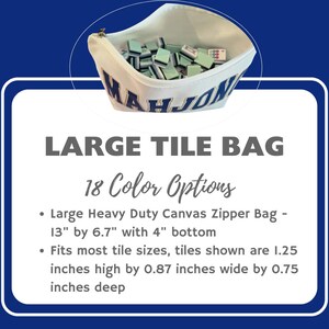May include: A white canvas zipper bag with the word MAHJONG embroidered in blue and gold, filled with light green and white game tiles. The text states the bag is 13 inches by 6.7 inches with a 4 inch bottom and holds 1.25 by 0.87 by 0.75 inch tiles.
