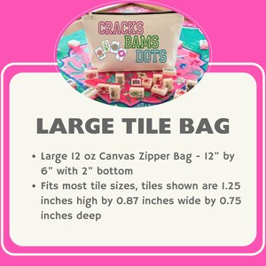 May include: A large canvas zipper bag with the text "CRACKS BAMS DOTS" in green, pink, and blue. The bag is beige and features a zipper closure. The bag is 30.5 cm by 15.2 cm with a 5 cm bottom.