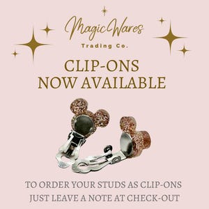 a picture of a pair of clip - ons on a pink background