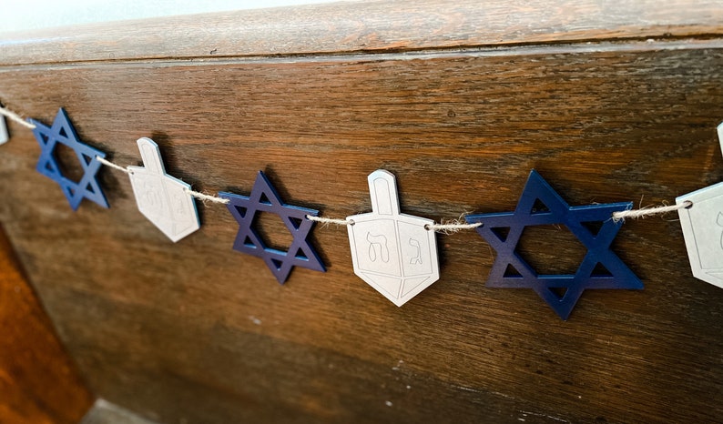 A banner with blue Stars of David and silver dreidels