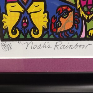 May include: A framed print of a colorful illustration titled "Noah's Rainbow" by Holly Sue. The print features a variety of animals, including seahorses, a crab, and a lion. The print is numbered 86/298.