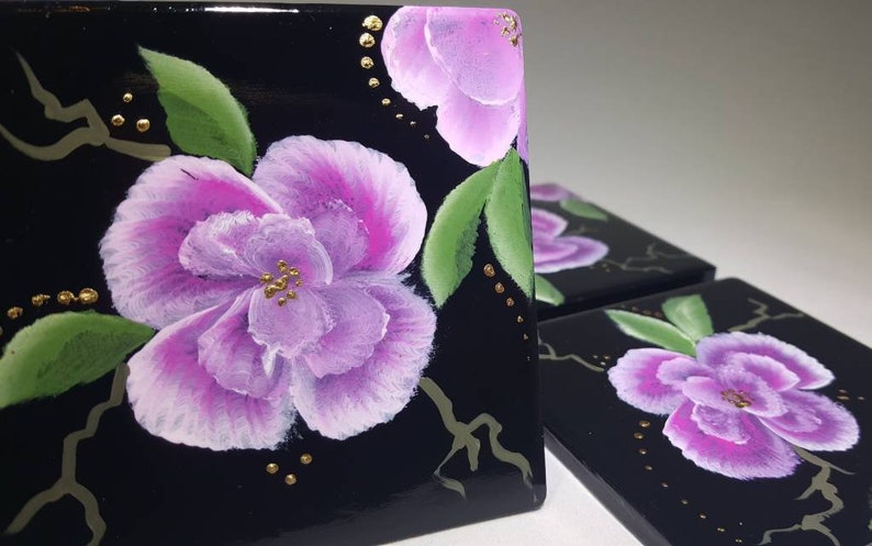 Hand painted pink and white flowers on a blaxk 4x4 ceramic tile coaster