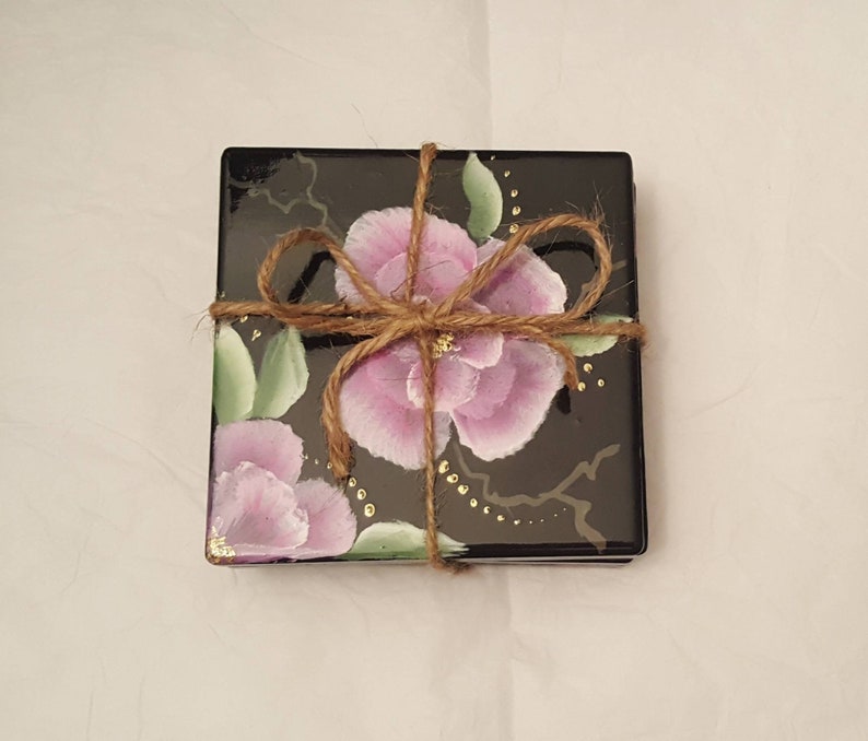 Hand painted pink and white flowers on a blaxk 4x4 ceramic tile coaster