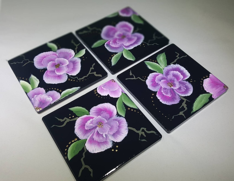 Hand painted pink and white flowers on a blaxk 4x4 ceramic tile coaster