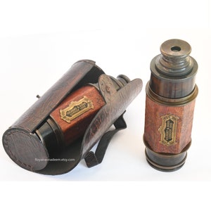 May include: Two antique brass telescopes with wooden barrels and leather carrying cases. The telescopes are engraved with "GILBERT & SONS LONDON 1891".