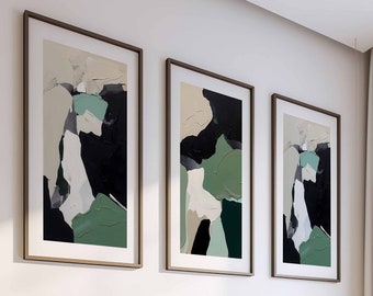 May include: Three abstract paintings in black, white, and green frames hang above a bed with a wooden headboard. The bed has a white duvet and a gray throw blanket.