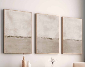 May include: Three abstract landscape paintings in muted brown tones hang on a white wall above a wooden bench and a white ottoman. A small potted tree sits on the bench.