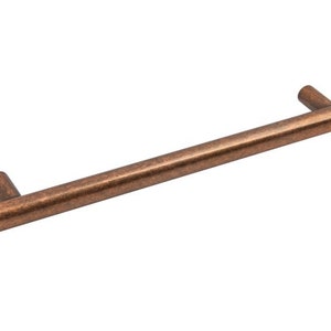 May include: A copper-toned cabinet pull with a smooth, cylindrical design. The pull is approximately 15cm long.