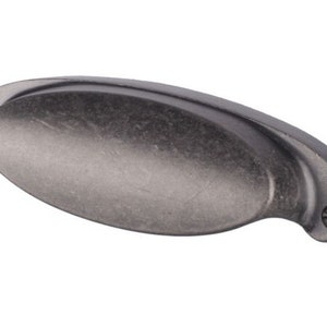 May include: A silver-toned, oval-shaped cabinet pull with a slightly curved design. The pull has a smooth, brushed finish.