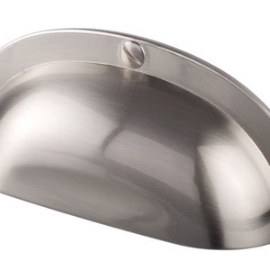 May include: A silver cabinet pull with a rounded, slightly domed shape. The pull has a smooth, brushed finish and four visible screws.