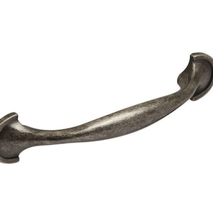 May include: A silver-toned metal cabinet pull with a curved design and rounded ends.
