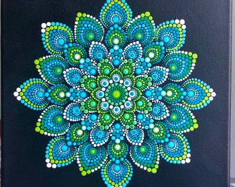 Colorful dot mandala on black stretched canvas 10" x 10" in shades of green & turquoise with white accents