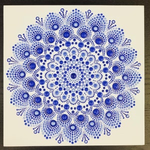 Blue burst dot mandala on white gessoed wood 10” x 10”
