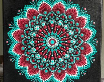 Vibrant dot Mandala on black stretched canvas 10" x 10" in shades of red & turquoise with white accents