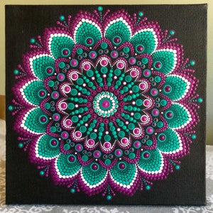 Vibrant dot Mandala hand painted on black stretched canvas 10&quot; x 10&quot; in shades of purple & green with white accents
