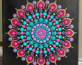 Vibrant dot Mandala on black stretched canvas 10" x 10" in shades of magenta, pink & turquoise with gold accents