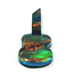 May include: A guitar-shaped pendant made of iridescent resin with a blue, green, and orange colour scheme.