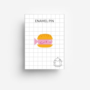 May include: Enamel pin featuring a cartoon fish inside a yellow hamburger bun. The pin is on a white background with a grid pattern. The text "ENAMEL PIN" is at the top of the image. The text "JUNGWIEALT" is at the bottom of the image.