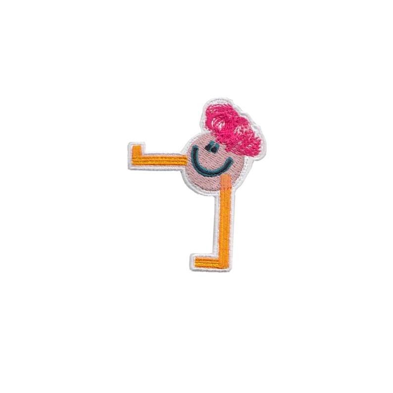 May include: Embroidered iron-on patch of a smiling cartoon person with pink hair and orange limbs.
