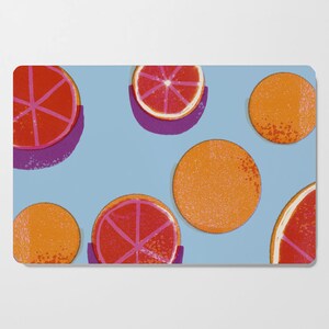 May include: A blue background with a pattern of orange and pink citrus fruit slices. The fruit slices are arranged in a random pattern.