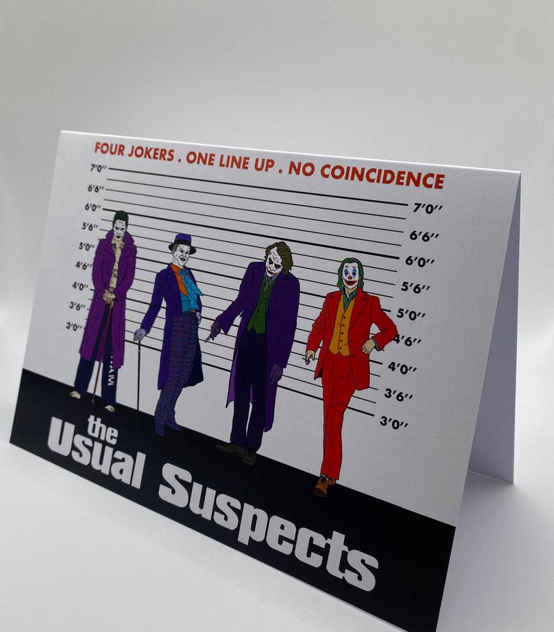 May include: A white card with a black and white image of four Jokers from the movie "The Usual Suspects" standing in a line-up. The Jokers are all wearing different suits and have different hairstyles. The card has a black banner at the bottom with the text "The Usual Suspects" in white letters. The card also has a white banner at the top with the text "FOUR JOKERS. ONE LINE UP. NO COINCIDENCE" in red letters.